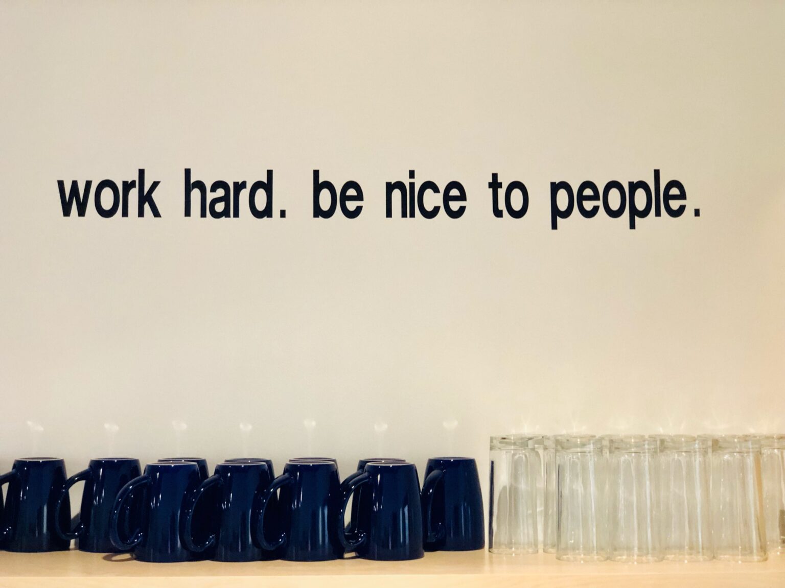 The Olio motto painted on the wall: work hard, be nice to people