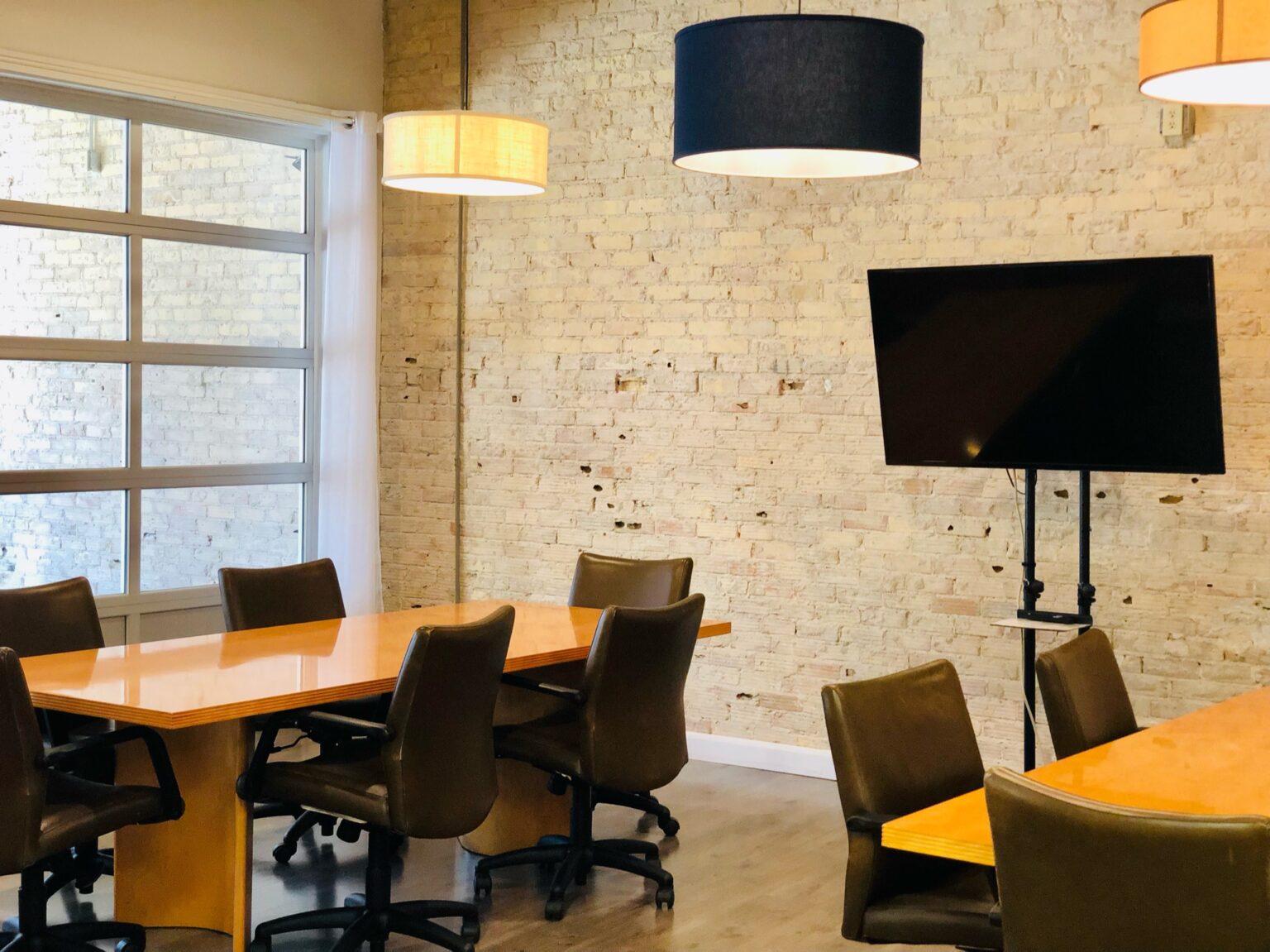 Meeting room with TV and brick wall